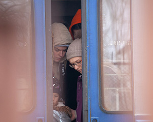 Image shows Ukrainian women fleeing shot through open train doors