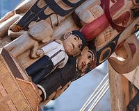 Image shows UBC's reconciliation pole, a wooden totem pole showing images of children