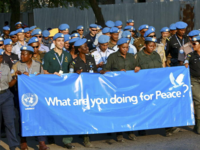 UNMIT Peacekeepers Celebrate UN International Day of Peace, holding a banner that reads "What are you doing for Peace?", Photo: UN Photo/Martine Perret, via flickr, CC BY-NC-ND 2.0